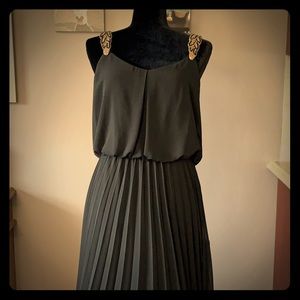 Long black dress with gold embellished straps.